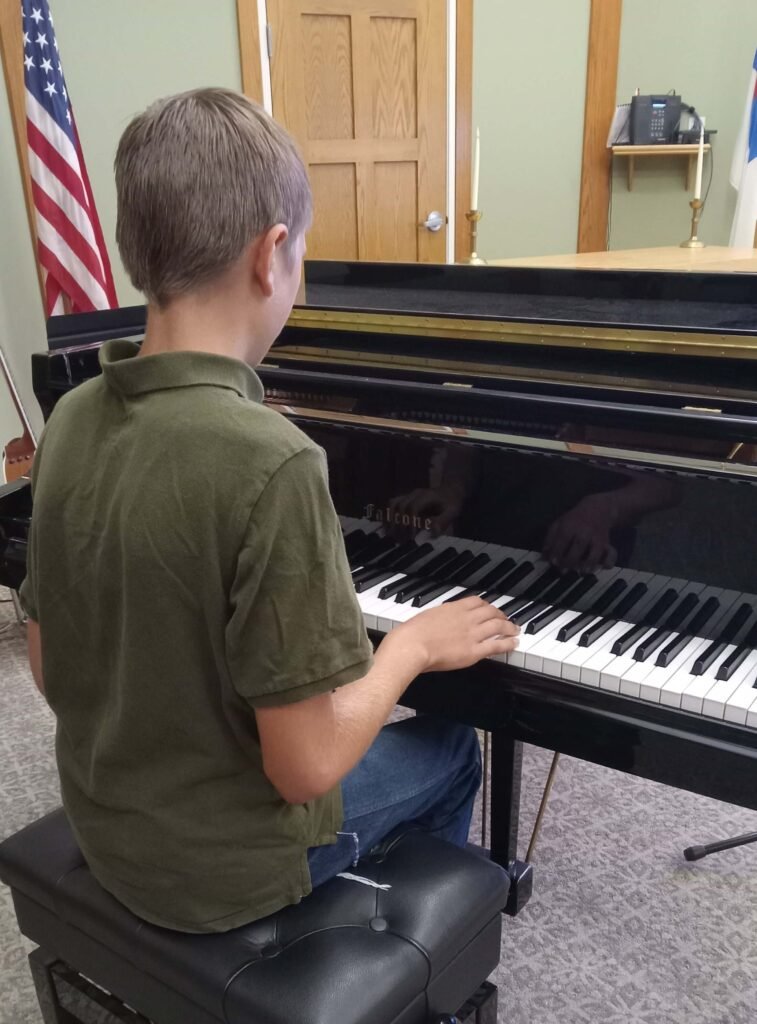 Elijah playing piano at the assisted living.